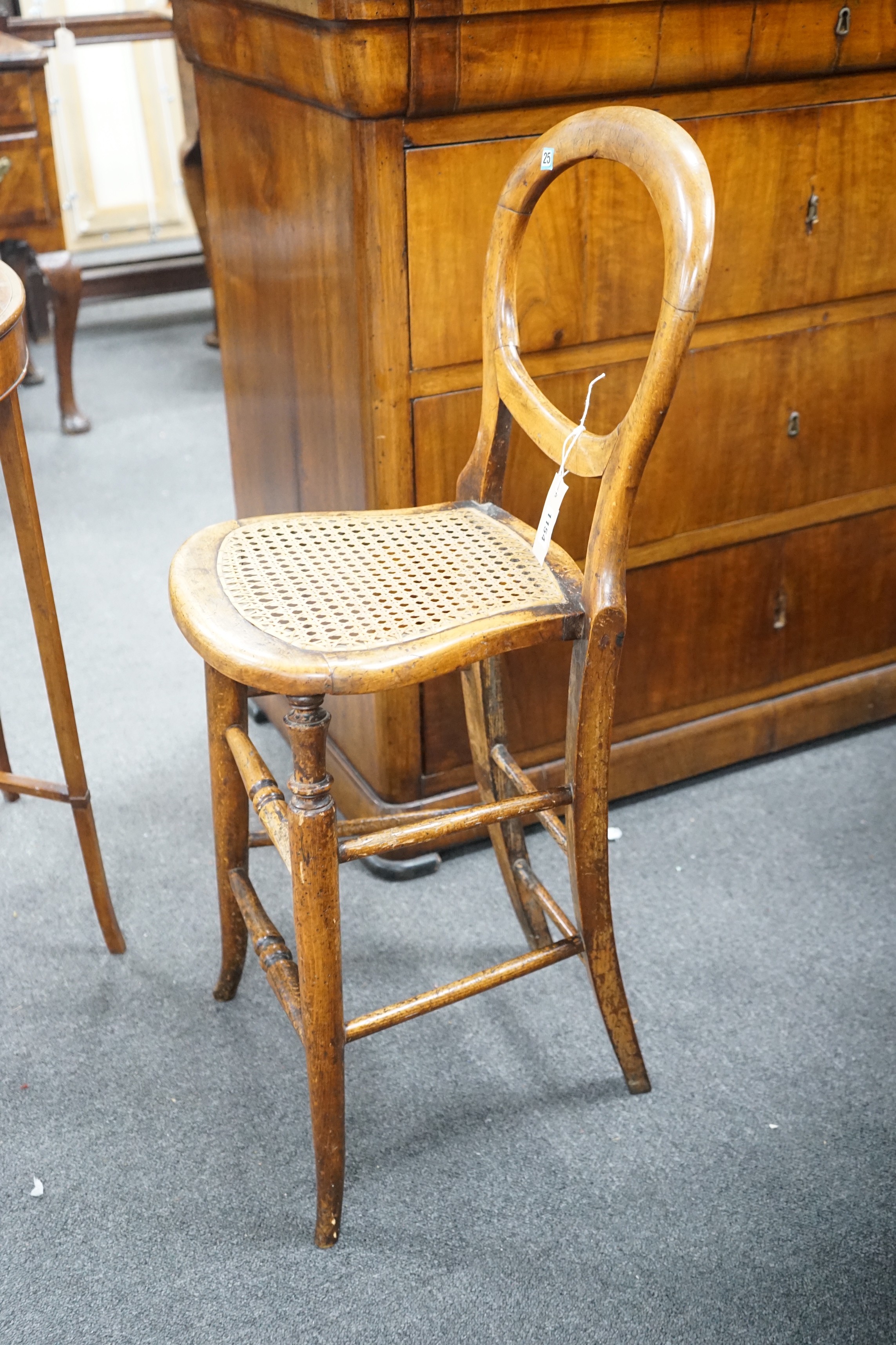 A Victorian caned beech child's correction chair and an Edwardian inlaid mahogany oval occasional table